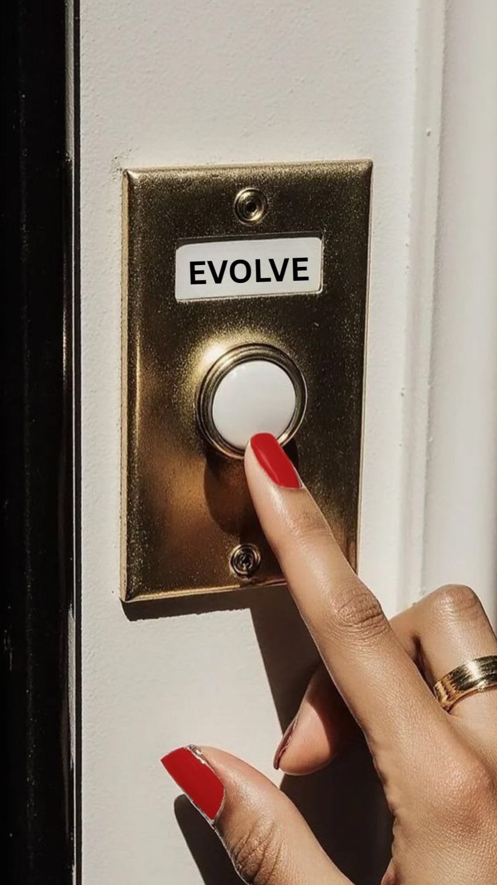 A hand pressing a brass button labelled Evolve