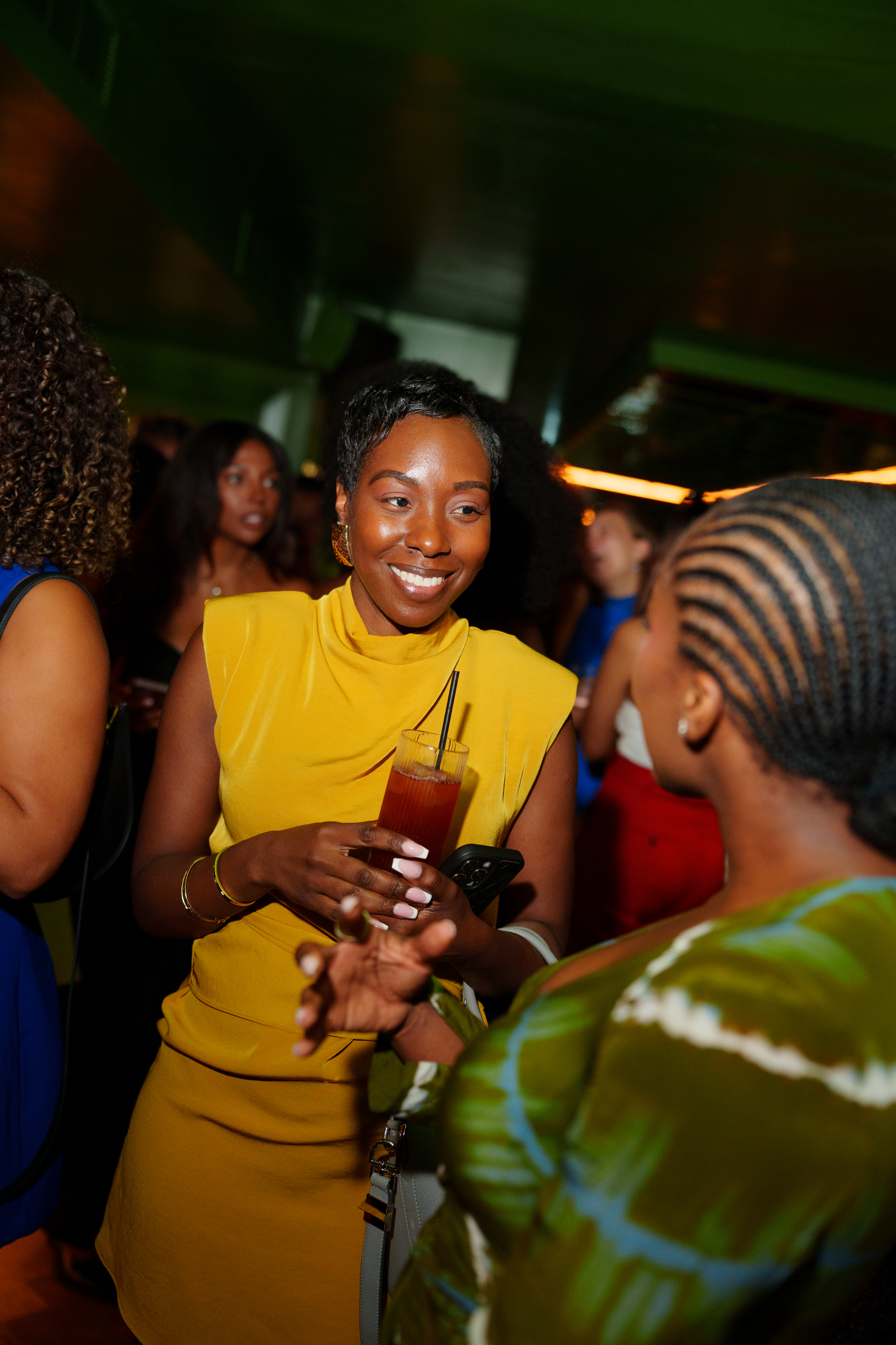 Two women engaged in a lively conversation over drinks