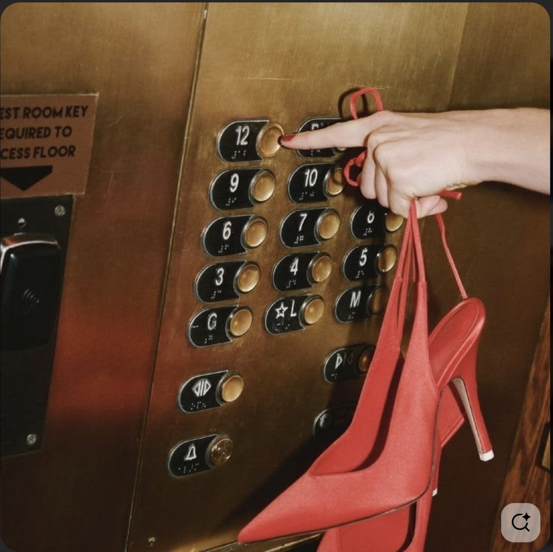 A guest holding red heels while selecting an elevator floor