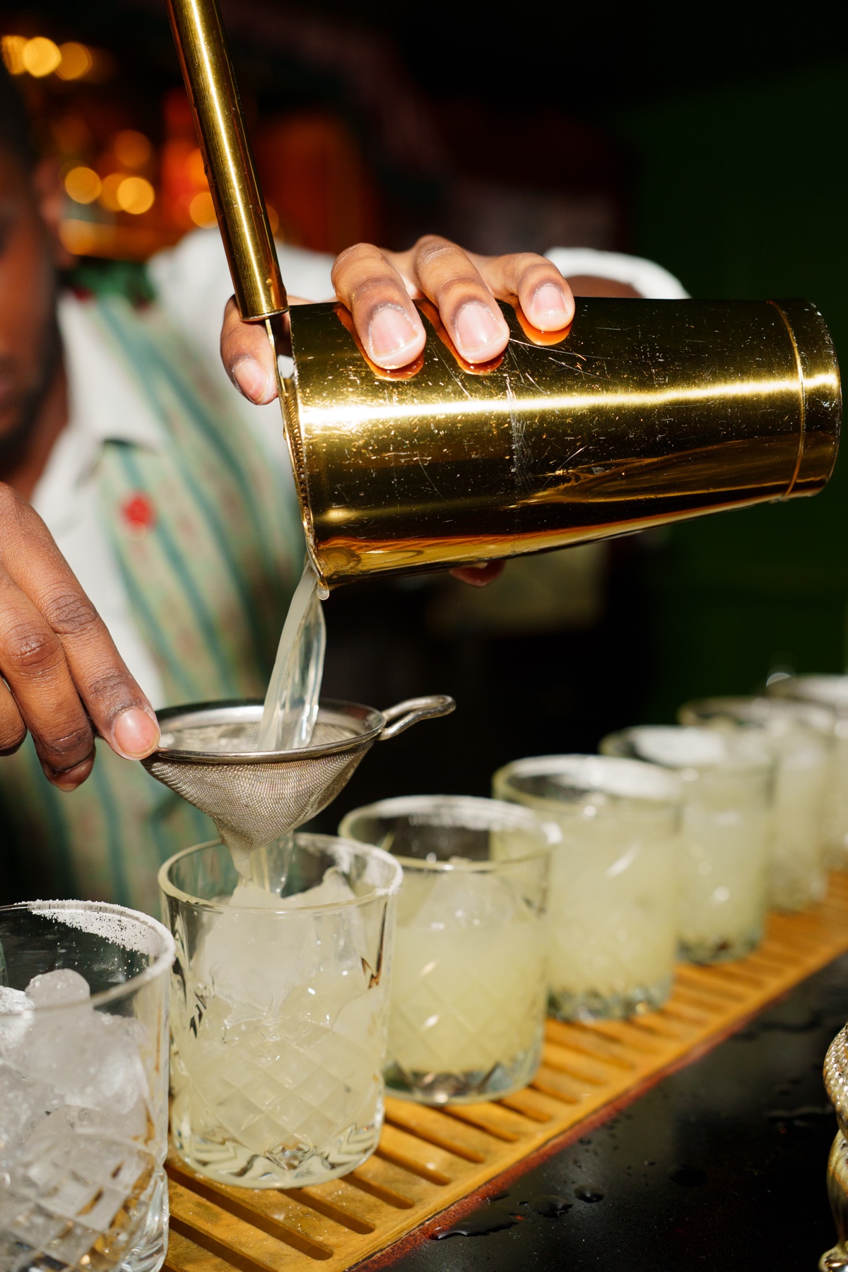 Cocktails being prepared by hand for guests