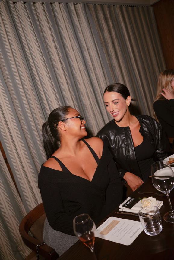 Two women enjoying a warm conversation over dinner